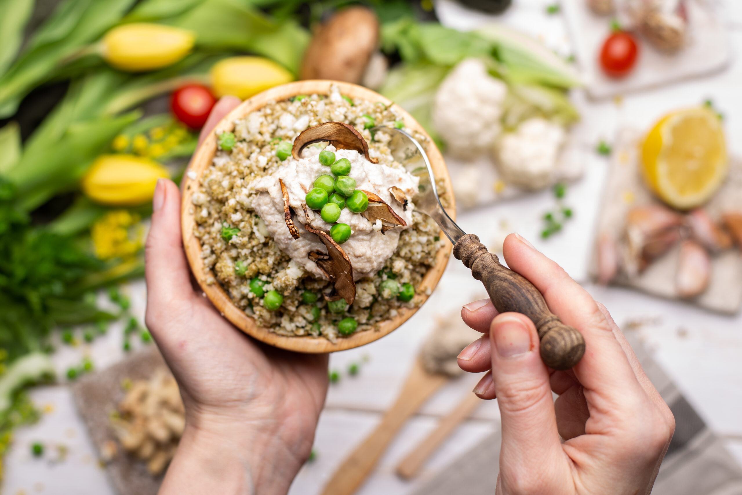 Close-up of a Vegan Gluten-Free Salad Bowl with Mushrooms, Cauliflower, Green Peas, and Creamy Plant-Based Dressing