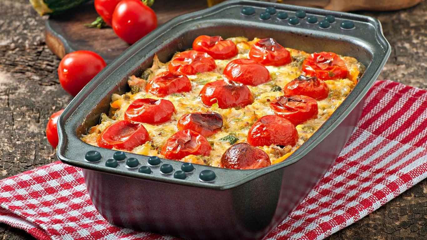 Vegan casserole topped with roasted cherry tomatoes, baked to perfection in a rustic baking dish.