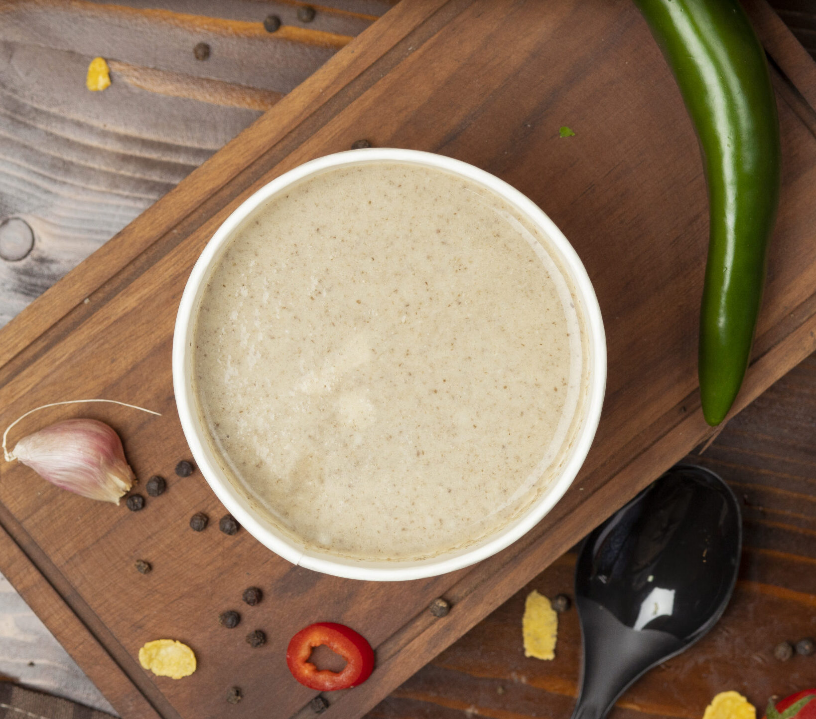 A bowl of creamy vegan mushroom gravy with fresh herbs - perfect for plant-based meals