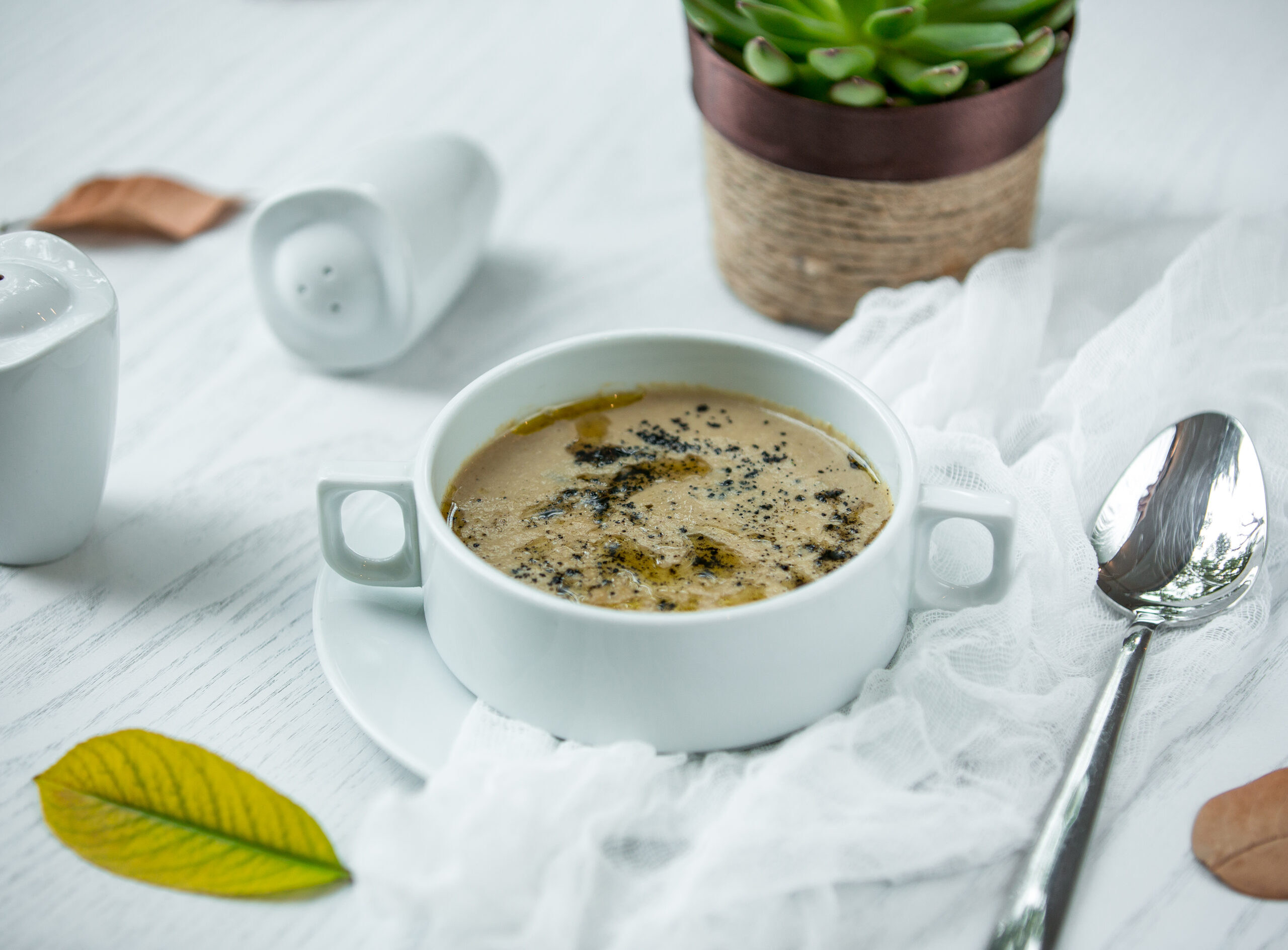 Creamy vegan mushroom gravy served with green vegetables, ideal for a healthy plant-based diet.